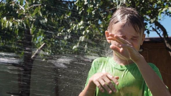 Kid Being Poured with Water in Garden