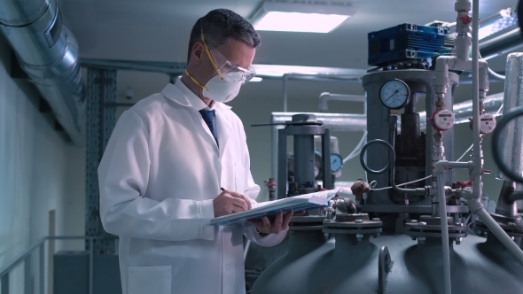 Man in Mask Holding the Notepad alt