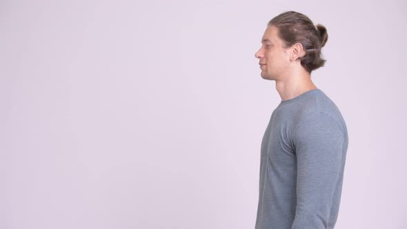 Profile View of Happy Handsome Man Smiling Against White Background