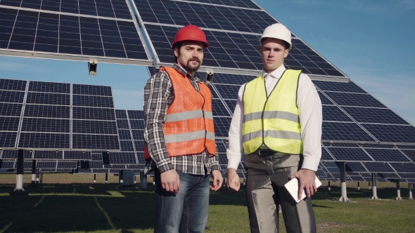 Two Solar Power Engeneers Looking in Camera