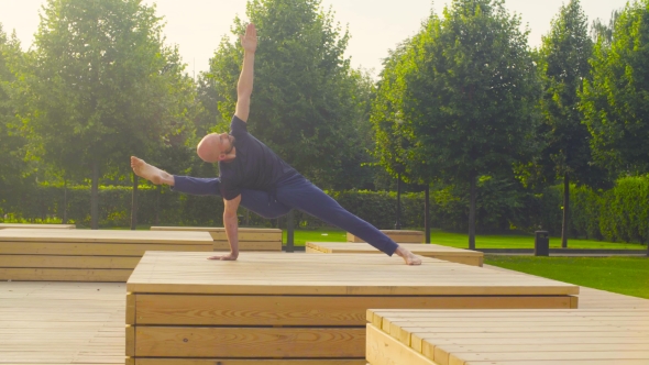 A Man Doing Yoga Exercises in the Park