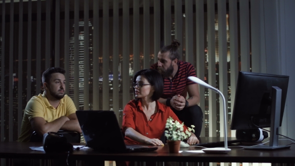 People Collaborating in Office at Night