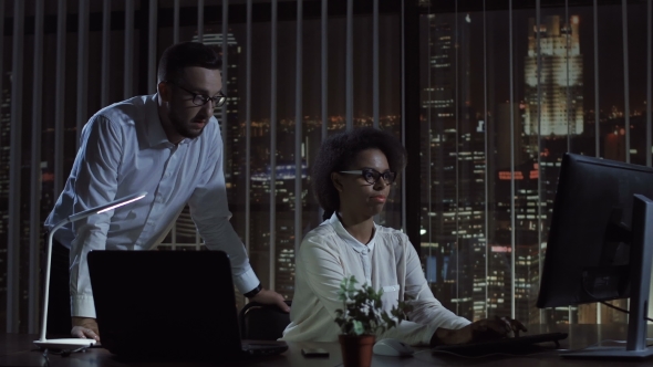 Man and Woman at Computer in Office