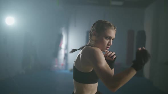 Young Female Fighter Trains His Punches Training in the Boxing Gym Female Trains a Series of Punches