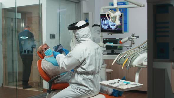 Stomatologist in Protective Suit Asking for Dental Xray