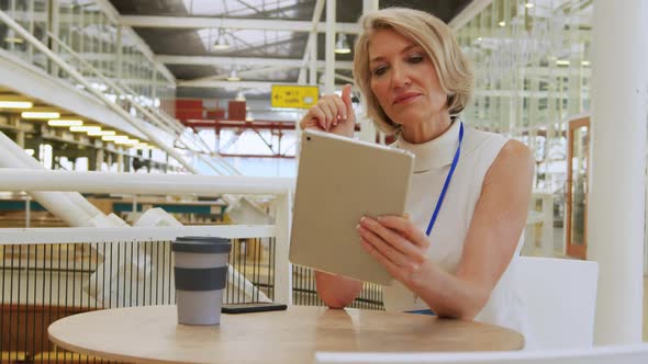 Businesswoman using a tablet in a conference foyer