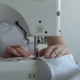 Woman Sewing a White Sheet - VideoHive Item for Sale