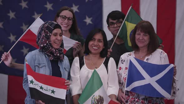 Group of people with different ethnicities holding flags