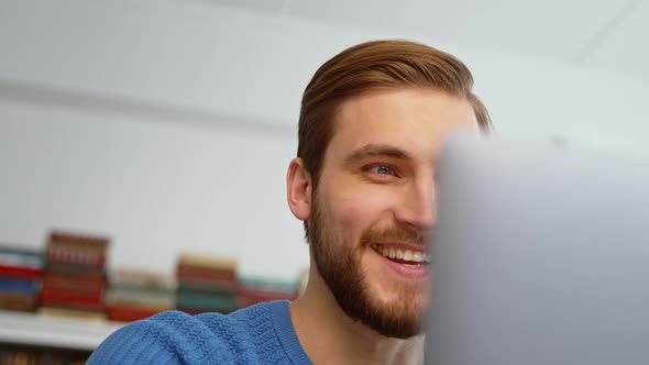 A young man talking on the phone receives good news. Emotional man in office