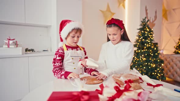 Happy Kids Girl and Boy Making Homemade Cake for Christmas at Light Home Interior
