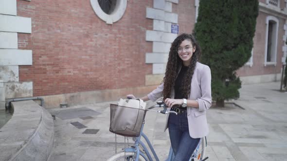 Beautiful Moroccan Lady With Long Curly Hair Posing With A Bicycle Outdoor