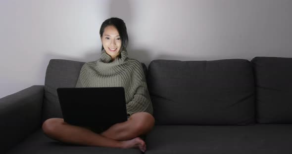 Woman working on laptop computer at night