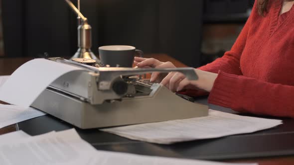 Closeup of Female Writer Using Typing Machine