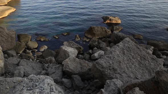 Sea Surf. Calm Waves Run Over the Rocky Shore Near the Golitsyn Trail in the Village of Novy Svet