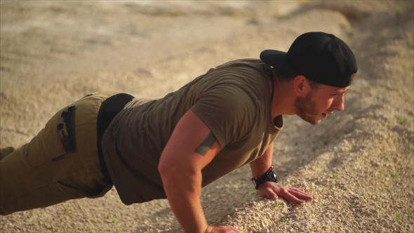 A Man in Good Physical Shape Is Squeezed Off the Floor in Nature on a Summer Day