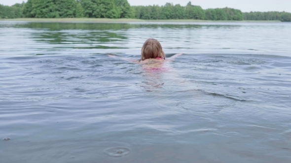 Woman Swimming in the Lake