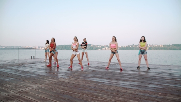 Pretty Women Dancing Synchronously on the Beach