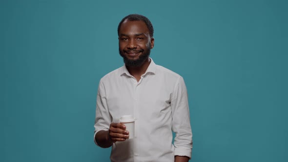 Portrait of Male Freelancer Enjoying Cup of Coffee in Studio