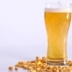 Beer Is Pouring Into Glass on White Background with Pickled Peanuts - VideoHive Item for Sale