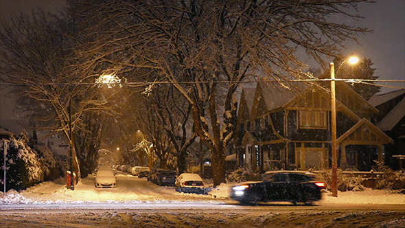 Suburbs With Passing Cars In Blizzard alt