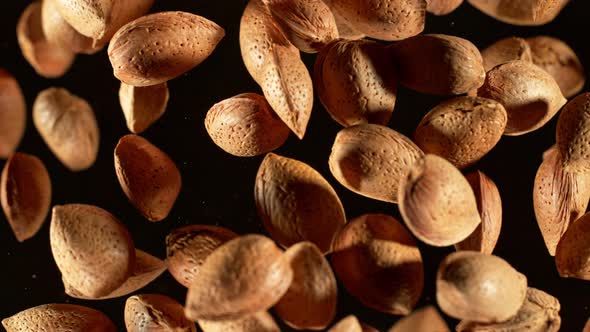 Super Slow Motion Closeup Shot of Flying Whole Almond Nuts Towards Camera on Black at 1000Fps