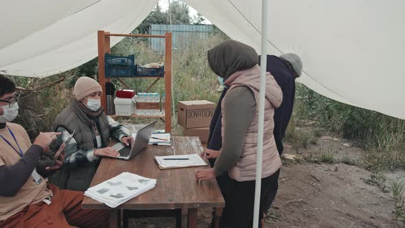 Social Workers Talking to Refugees at Tent City