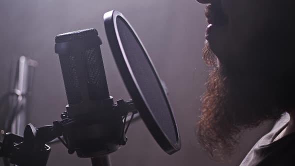 A Man Reads Text in a Recording Studio