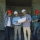 Builders Team On Construction Site Discussing Plan Of Project With Architect And - VideoHive Item for Sale