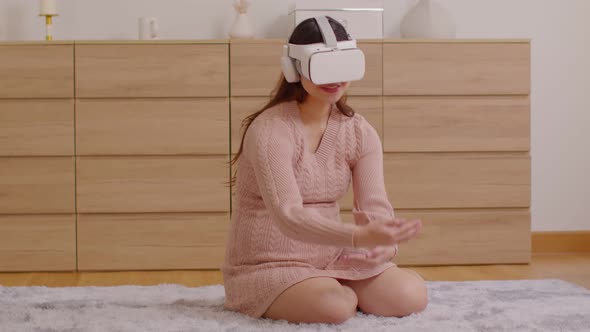 Pregnant woman using virtual reality glasses for practice tutorial to take care of a newborn baby