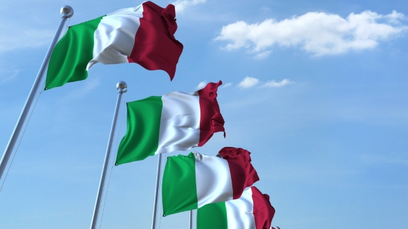 Row of Waving Flags of Italy Agaist Blue Sky alt