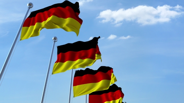 Row of Waving Flags of Germany Agaist Blue Sky alt