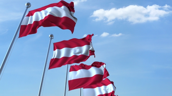 Row of Waving Flags of Austria Agaist Blue Sky alt