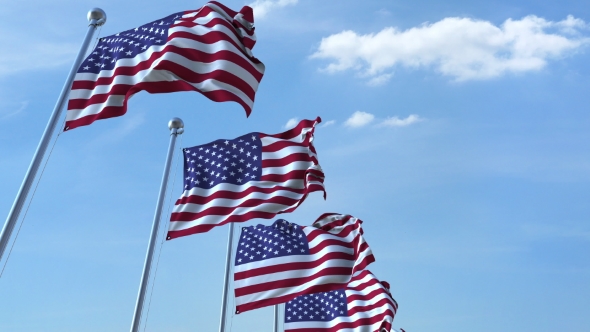 Row of Waving Flags of the United States Agaist Blue Sky alt