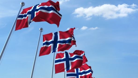 Row of Waving Flags of Norway Agaist Blue Sky alt