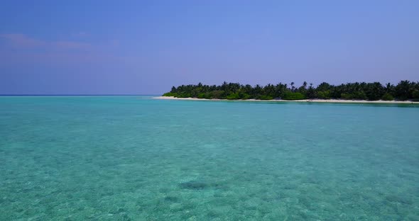 Beautiful birds eye island view of a white sand paradise beach and blue sea background in colorful 4