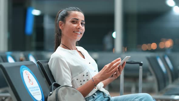 Woman Looking at Camera at Airport