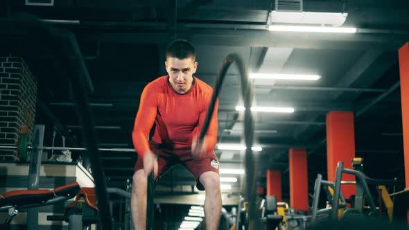 A Man Is Doing Crossfit Exercises with Ropes