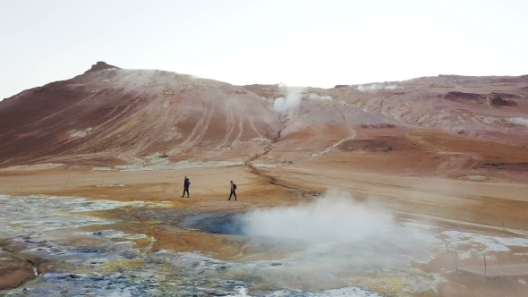 Gray Geysers in Iceland Trekking Tourists