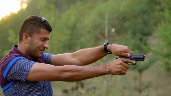 Young Arab Man Is Shooting From a Gun alt