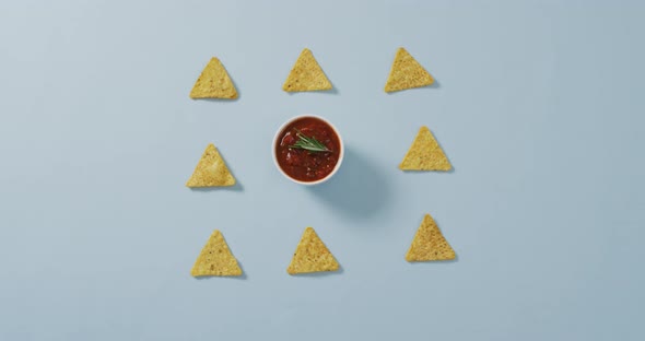 Video of tortilla chips and salsa dip on a grey surface