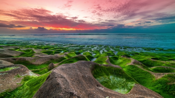 of Beautiful Sunset on the Balangan Beach with Frozen Volcanic Funnels Covered with Algae on the