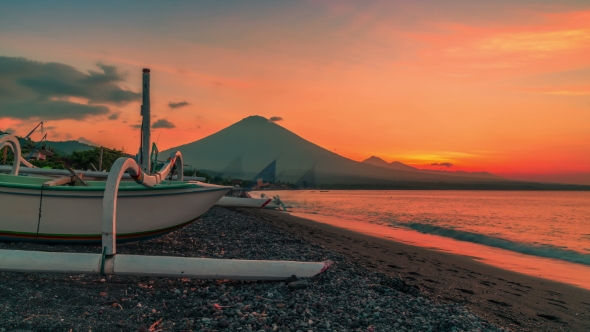 Sunset Overlooking the Agung Volcano in the Background of a Fishing Boat on the Beach of Jemeluk Bay