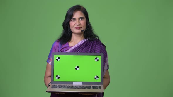 Mature Beautiful Indian Woman As Call Center Representative Showing Laptop