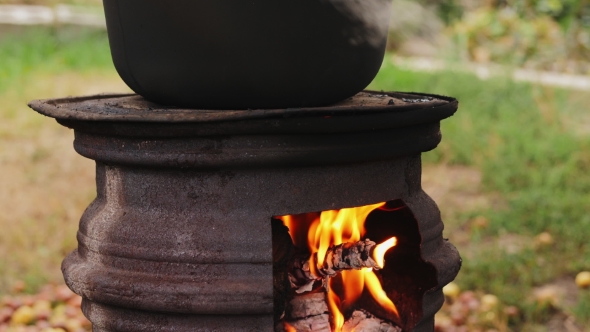 Cooking Outdoors in Cast-iron Cauldron