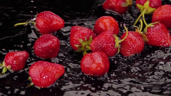 Ripe Strawberries Falls on the Table.