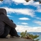 Girl in a Hoodie Sits and Contemplates the Sky - VideoHive Item for Sale