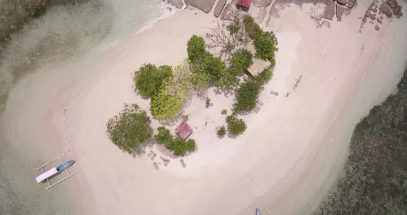 Top Shot of Small Island with Few Trees on It and Two Boat Parked