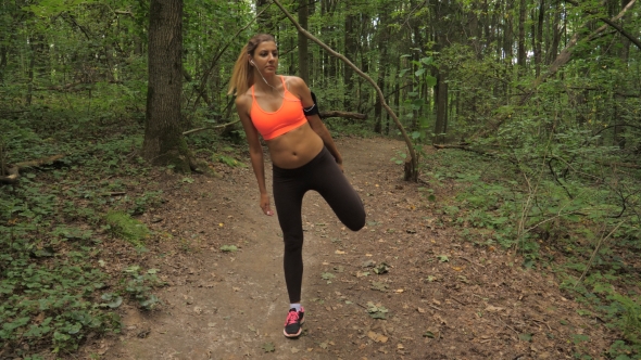 Pretty Sporty Woman Before Running In The Park Knead And Stretch Muscles