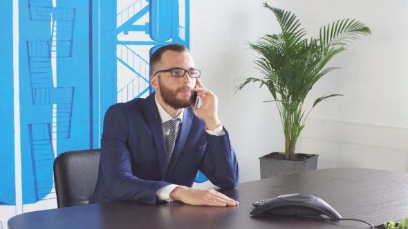 Teleconference - Business People Hand Dialing a Number on a Modern Conference Phone