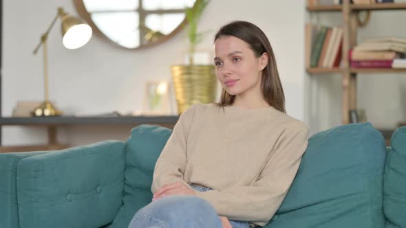 Young Woman Coming Back Opening Laptop From Sofa 